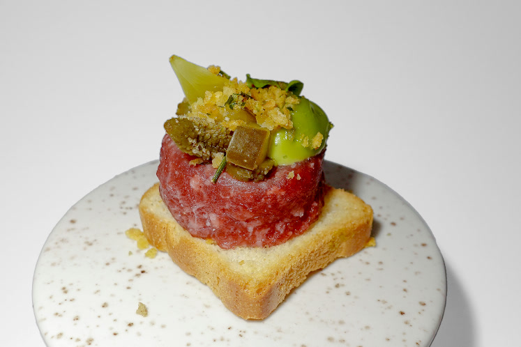 Toast ossenworst, atjar of Amsterdam pickles, crispy onion and bacon with chive cream